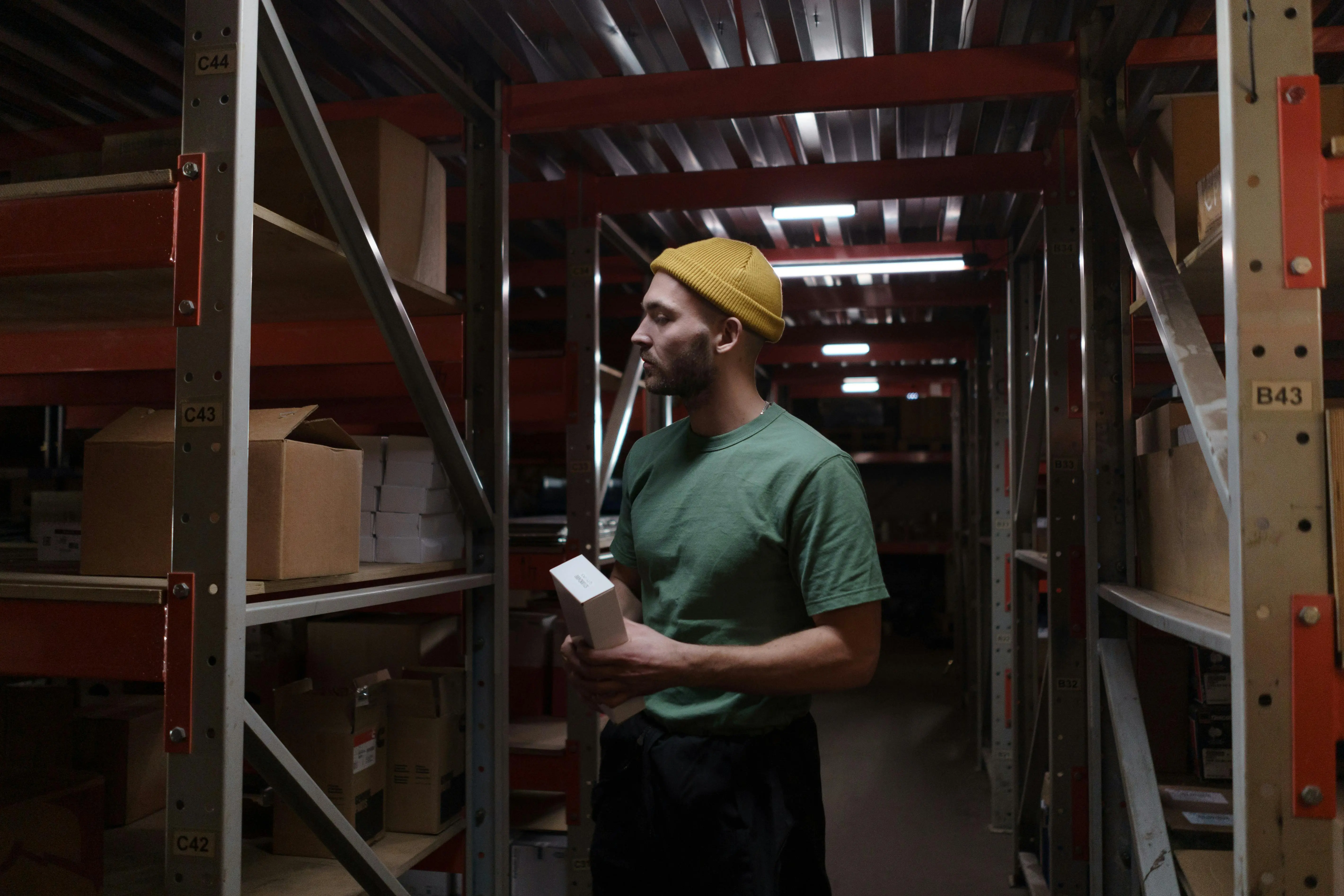 A store worker checking stock in a warehouse